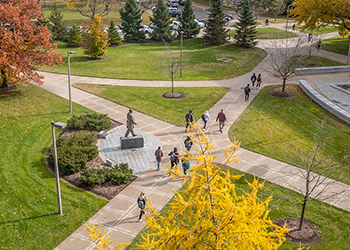 An aerial view of students walking by the Hannah statue in the fall.