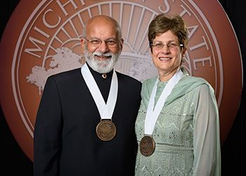 Shashi and Margaret Gupta pose with their award medallions