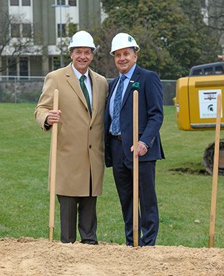 President Stanley poses with Doug Meijer and some shovels at the groundbreaking