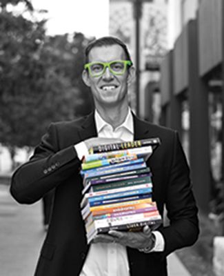 Best-selling author Erik Qualman poses with his published books.