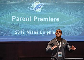 Kaleb Thornhill, '07 (Social Science), M.A. '09 (Education) talks shop with families of new NFL players.