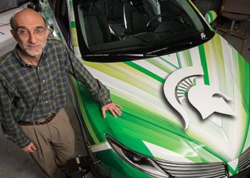 hayder radha poses with MSU's autonomous car