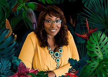 kinitra brooks surrounded by lush flowers