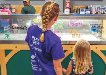 Kids look at the array of Dairy Store ice cream flavors