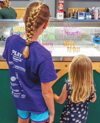 Kids look at the array of Dairy Store ice cream flavors