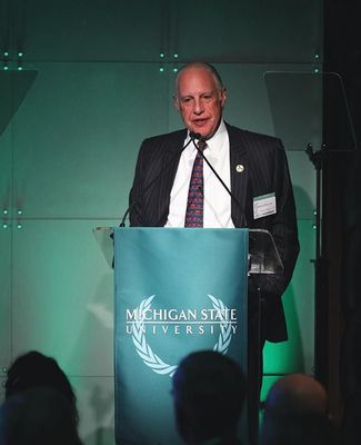 Edward J. Minskoff stands at podium