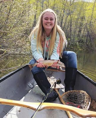 Ali Stark holds fish in her hands