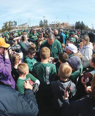 Coach Mark Dantonio signs autographs for fans