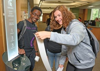 students receive their short story from library kiosk