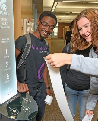 students receive their short story from library kiosk