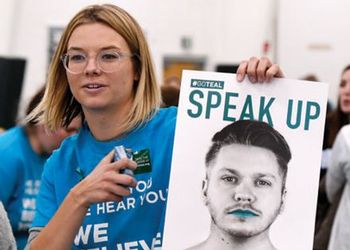 MSu student holding speak up poster