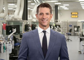 Kevin Conroy stands in Exact Sciences laboratory.