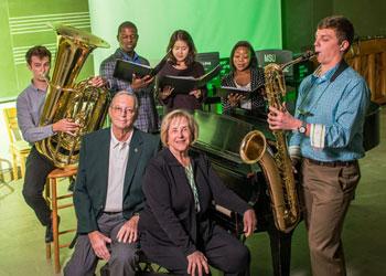 Saxophonist Travis Sinclair and other College of Music students surround Jack and Dottie Withrow (center, bench), who recently created an endowment to help music students develop business skills.