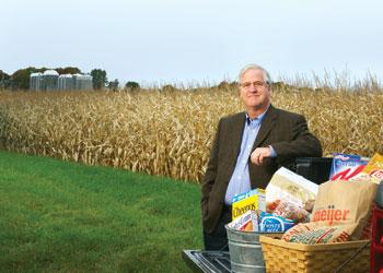 David Closs, the John H. McConnell Endowed Chair, poses with some of the food products that have benefited from the work of MSU’s #1 ranked program in supply chain management in the Eli Broad College of Business.