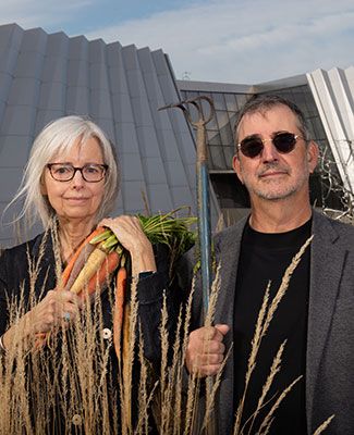 dave giordan and cindy lounsbery pose in a parody of the American Gothic painting