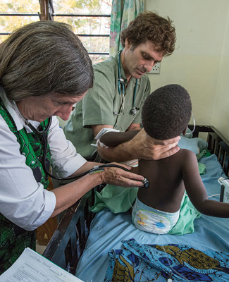 Terry Taylor conducting a medical examination on a child