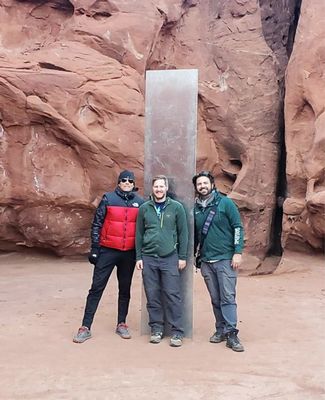 Spartans stand in front of Utah monolith