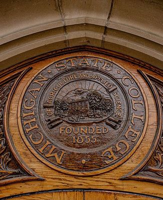 University seal engraved in wood. 