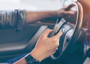 Distracted driver texting on phone