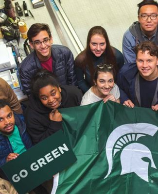 CAL students hold Spartan helmet flag