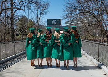graduates on the library bridge