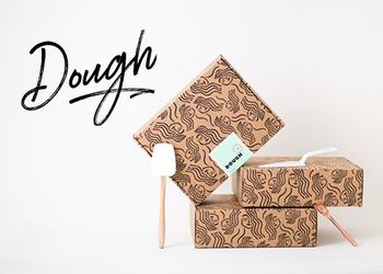 Dough logo overlaid Doughh product boxes stacked.