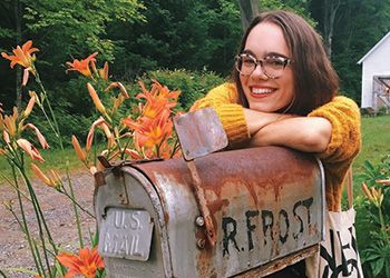 Leila Chatti poses with the mailbox of Robert Frost.