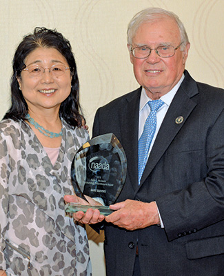 Photo of Eiko and Gary Seevers holding the 2016 Outstanding Philanthropist Award from the National Agricultural Alumni and Development Association