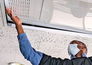 IPF worker installs air purifier 