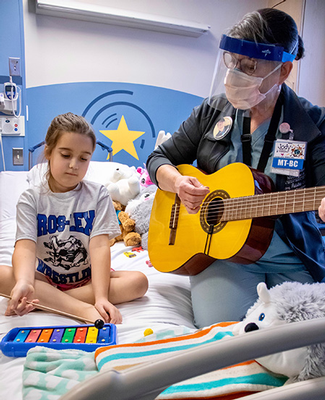 Jody Stark conducts music therapy session at the Children's Hospital of Michigan. 