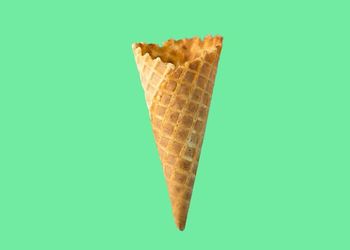 Ice cream cone on green background