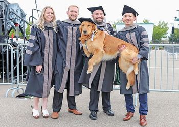 veterinary medicine grads with a dog