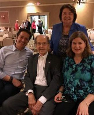 Angelos and Betty Vlahakis and their two grown children, celebrating Vlahakis' 90th birthday