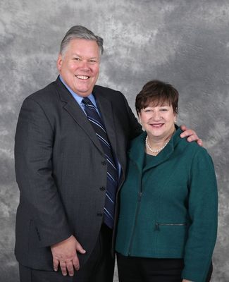 Jim and Sherry Bradow pose against a gray background