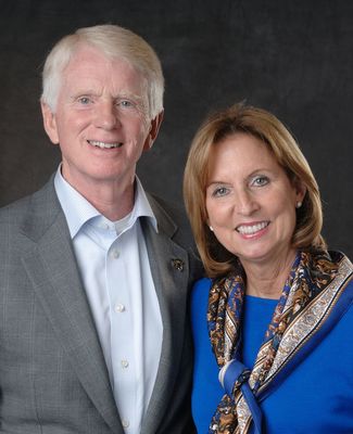 Craig and Vicki Brown, in formalwear, pose for a portrait