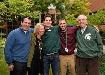 The Riguardi family, dressed for a football game, pose together on campus