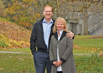 Joe and Laurie Thorp pose near the Beal Garden pond in the fall