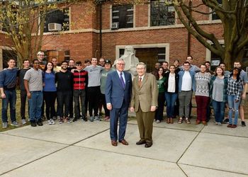James Billman poses with College of Music dean Forger outside the music building with students.