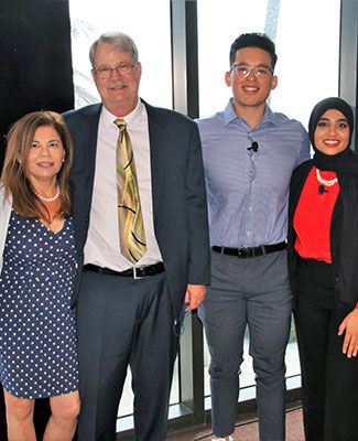 Dr. Thomas Wielenga, his wife Sue, and two Weilenga scholars