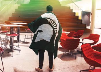 MSU student with Spartan flag
