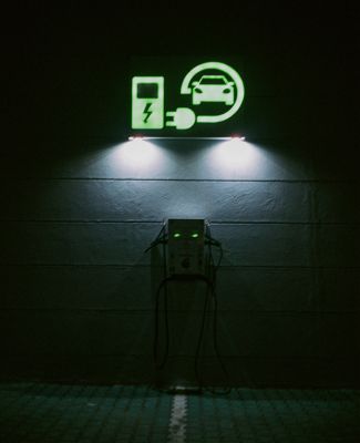 Electric Vehicle charger glows green.