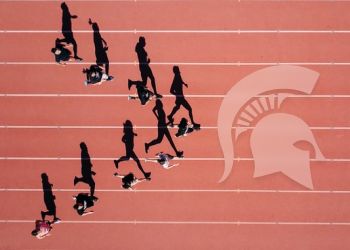 Runners on a track aerial view. 