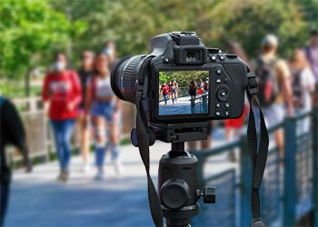 Camera taking shot of students on campus