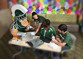 Sparty and James Madison College Students hard at work studying