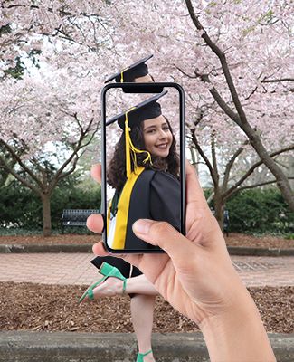 Lyman Briggs College graduate Joanna Colovas in graduation gown