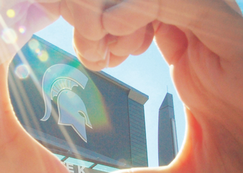 Spartan Helmet on stadium and hands forming heart