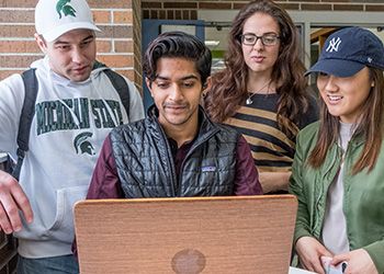 MSU students studying in front of a computer.