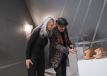 alan and rebecca ross look at a Zaha Hadid artifact in a glass case at the MSU Broad Art Museum