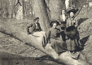 Women pose next to Red Cedar River