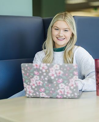 Jennifer Laukonis, a student, sits behind her laptop computer in the MSU Library
